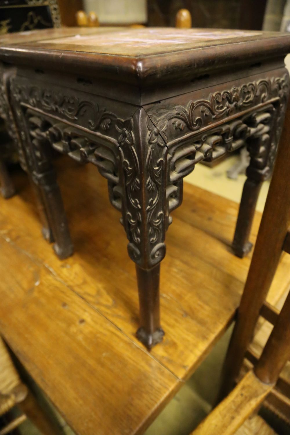 A pair of Chinese rectangular carved and pierced hardwood jardiniere stands with rouge marble tops, width 35cm, height 47cm